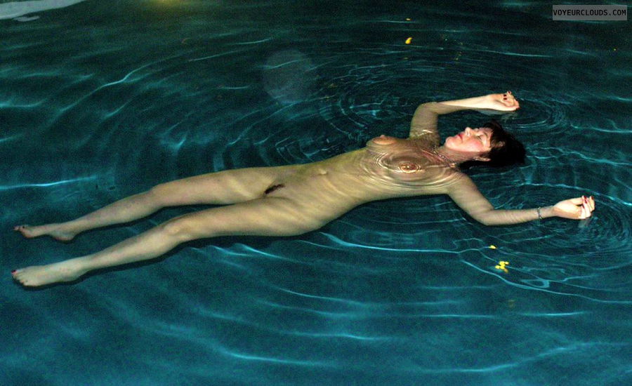 swinger wife, nude in the hotelpool, big boobs, lying on the waters